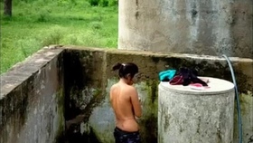 Indian woman indulges in risqué behavior while bathing outdoors