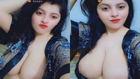 A girl with large breasts shows off her curves