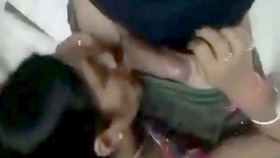 A South Asian wife gives oral pleasure to a penis and its testicles