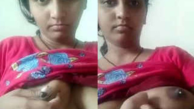 A South Asian woman squeezes her nipple