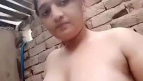 Arousing Indian woman tantalizes with her ample bosom while bathing