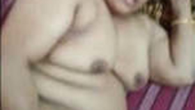 A middle-aged Indian woman engages in sexual activity in various video segments