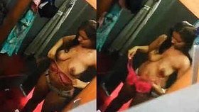 Indian girl in lingerie changes clothes in a fitting room