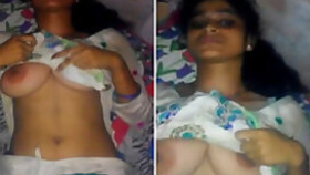 Indian fellow plays with her juicy XXX tits until she notices camera